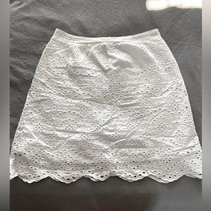 White eyelet pull-on skirt with elasticized waistband on the back.